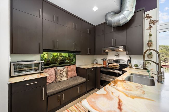 Stunning honey onyx counters, a built in aquarium with a seat are the best things! | Image 22