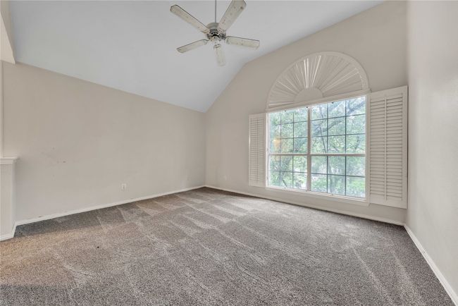 Spare room featuring carpet flooring, a ceiling fan, and lofted ceiling | Image 29