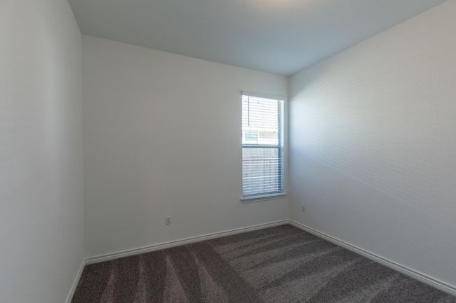 Spare room featuring baseboards and dark carpet | Image 25