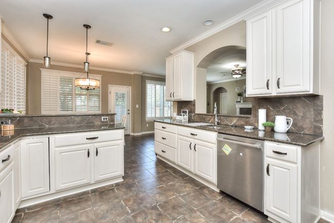 This kitchen boasts an abundance of cabinets and counter space for meal prep! | Image 14