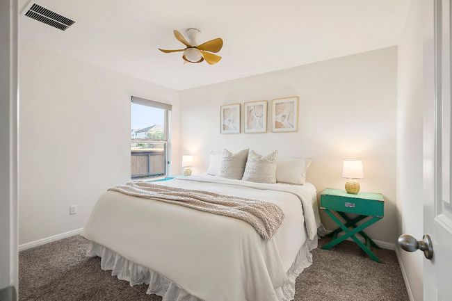 Each guest bedroom offers comfortable accommodations with plenty of natural light. | Image 19