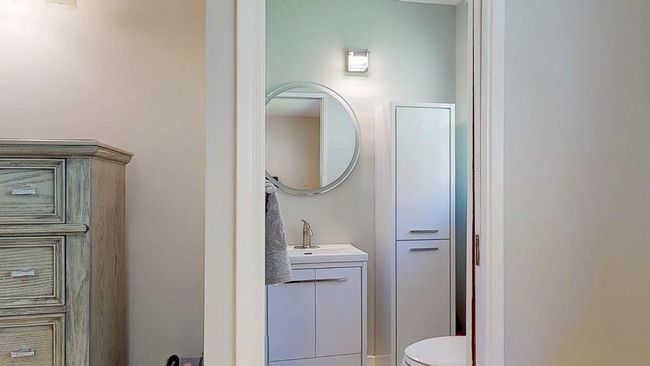Bathroom with toilet, storage, and vanity | Image 16