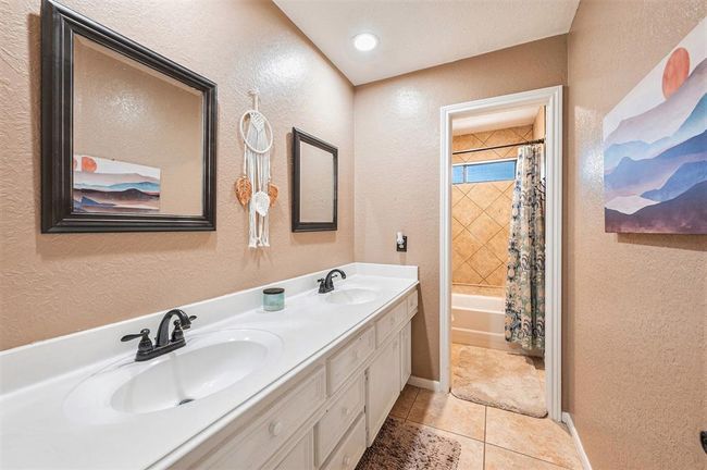 Upstairs full bathroom with a dual sink vanity and tub/shower combination. | Image 19