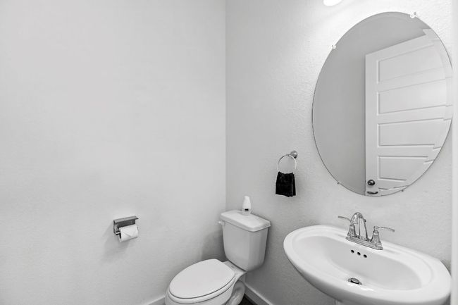 Bathroom featuring a sink, toilet, and baseboards | Image 5