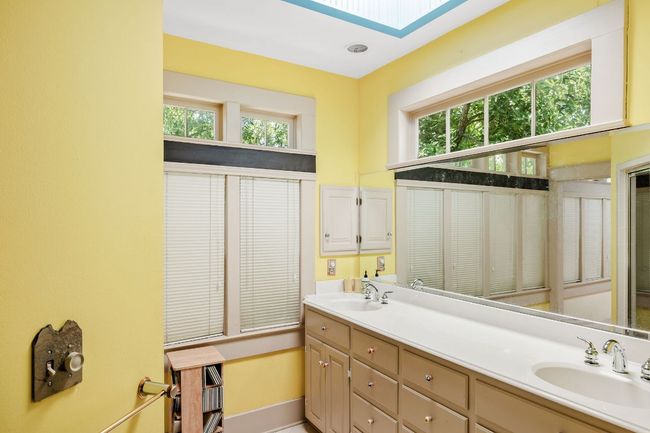 Full bathroom featuring double vanity and a skylight | Image 24
