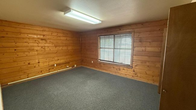 Carpeted empty room with wooden walls | Image 14