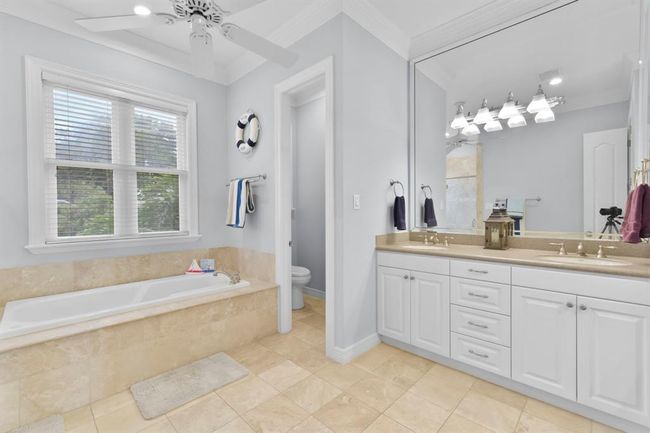 The primary bath features double sinks, a luxurious soaking tub, and a walk-in shower. | Image 24