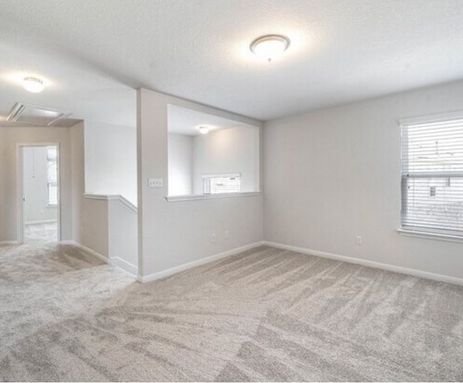 Carpeted empty room featuring attic access and a textured ceiling | Image 14
