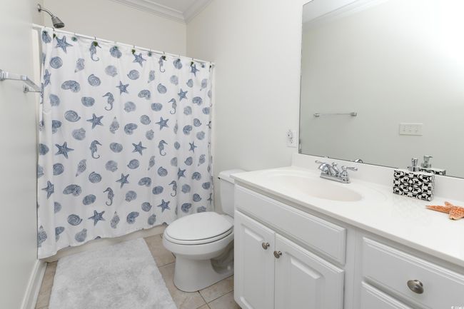 Bathroom with toilet, ornamental molding, tile patterned flooring, and vanity | Image 22