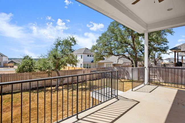 Balcony with a ceiling fan, a patio area, and a residential view | Image 27