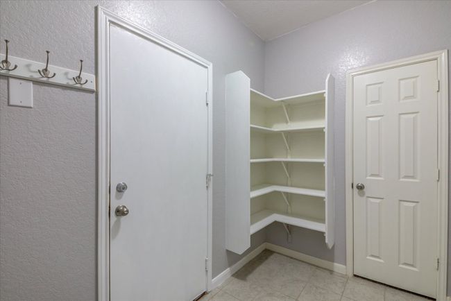 The door (on the left)leads to the garage. Built in cabinetry for your pantry. | Image 12