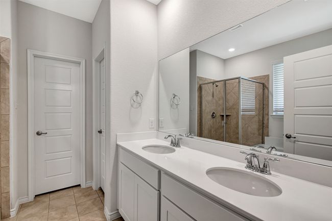 Bathroom with a stall shower, double vanity, and tile patterned flooring | Image 20