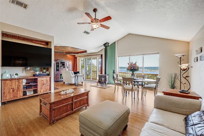 Upstairs, this Open Floor Plan allows easy flow from the Kitchen, thru the living area to the perfect location for Dining! What a Picturesque setting! | Image 24