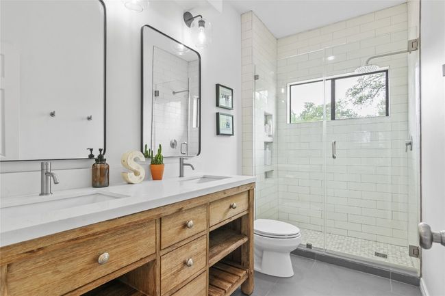 Full bathroom that serves both upstairs bedrooms. Beautiful subway tile & white oak vanity with quartz countertop. | Image 27