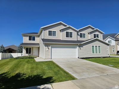 View of front of property with a front lawn and a garage | Image 1