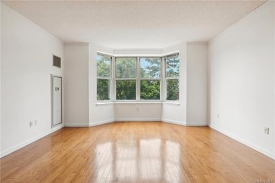 Unfurnished room featuring ornamental molding, light hardwood / wood-style floors, and a textured ceiling | Image 3