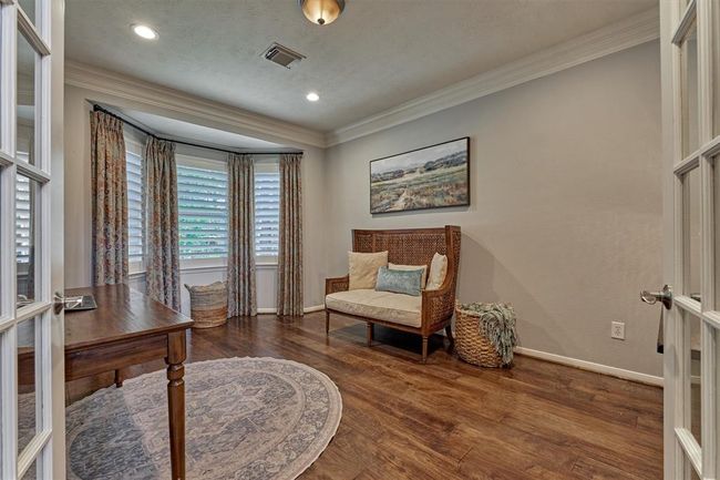 Home Office/Study entry is double glass doors and is accented with front facing windows, beautiful floors and crown moulding. | Image 7