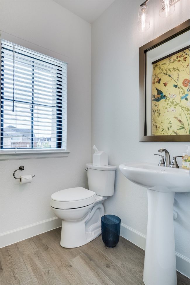 Half bathroom featuring toilet and wood finished floors | Image 26