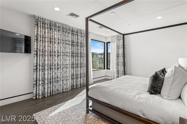 Bedroom with wood finished floors, visible vents, recessed lighting, and baseboards | Image 42