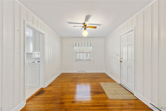 Spare room featuring ornamental molding, a ceiling fan, hardwood / wood-style floors, and visible vents | Image 11