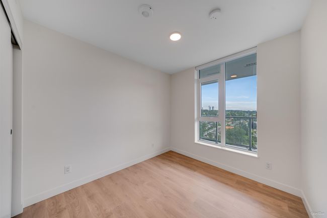 Unfurnished room featuring baseboards, light wood-style flooring, and a smoke detector | Image 10