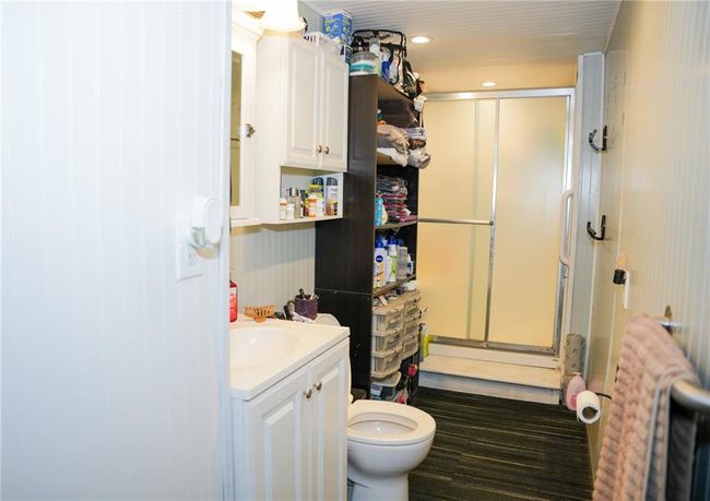 Bathroom with toilet, a stall shower, and vanity | Image 22