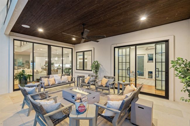 This covered patio is the perfect extension of indoor-outdoor living. | Image 38