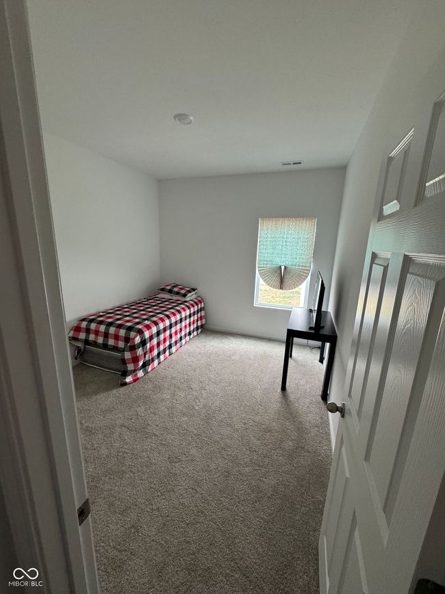 carpeted bedroom featuring visible vents | Image 17
