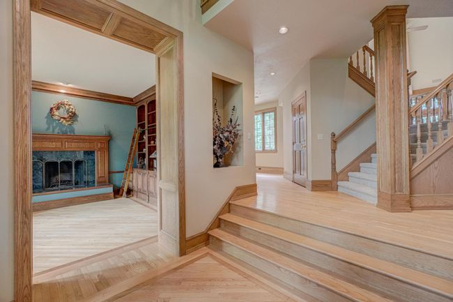 The walnut inlay on the floors is highlighted by the beautiful hardwoods installed at a diagonal and the sunlight that pours through the large windows | Image 29