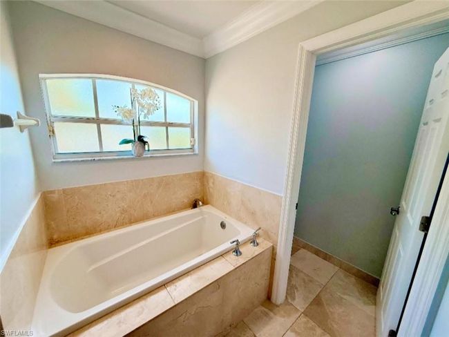 Bathroom with ornamental molding and a bath | Image 20