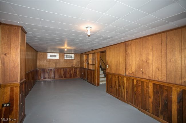 Basement featuring wooden walls and stairs | Image 23