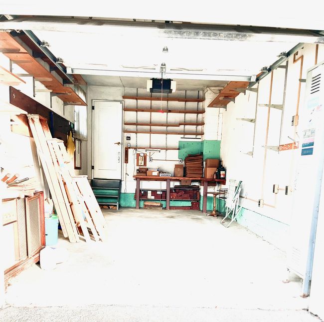 Garage featuring a workshop area and a garage door opener | Image 44