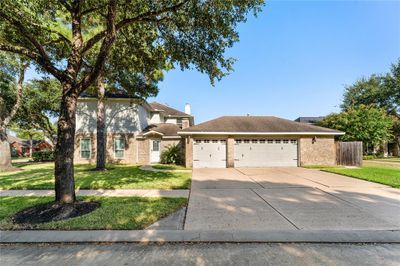 Triple wide driveway behind the converted guest cottage, with its own private entrance | Image 3