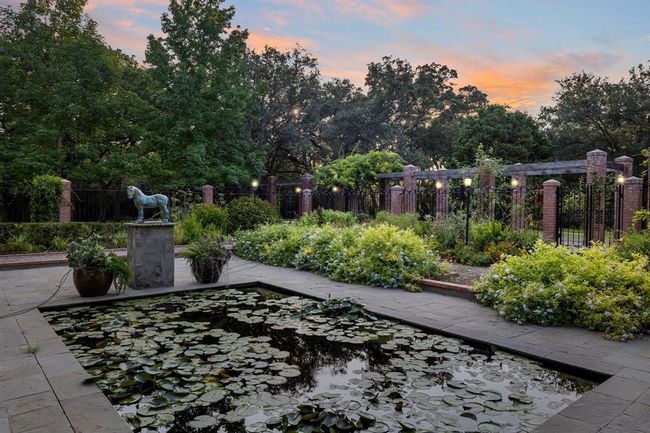 [The Garden of the Blue Horse] emerges as an exquisite formal sunken garden, featuring a captivating 12'x20' reflecting pool at its heart. The pool is elegantly encircled by a Bluestone patio, harmoniously merging the elements of water and stone. Graceful pathways wind through this enchanting space, flanked by expansive formal flower gardens that add a burst of color and fragrance to the landscape. | Image 34
