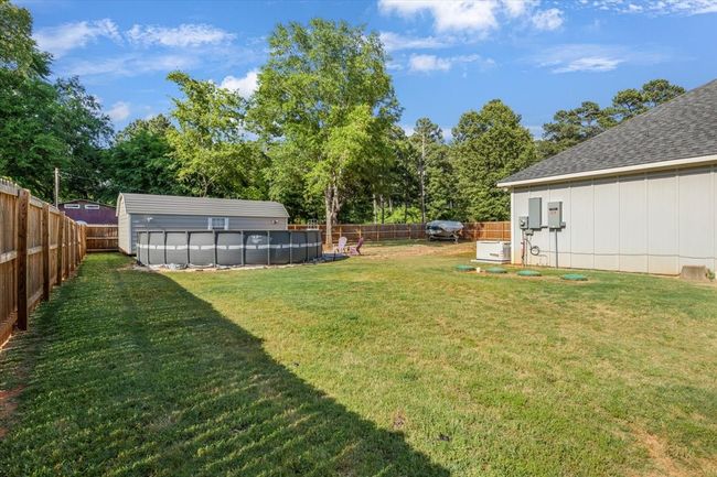 View of yard with a fenced backyard and a fenced in pool | Image 30