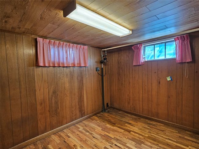 Below grade area with wooden ceiling, wood finished floors, and wooden walls | Image 22