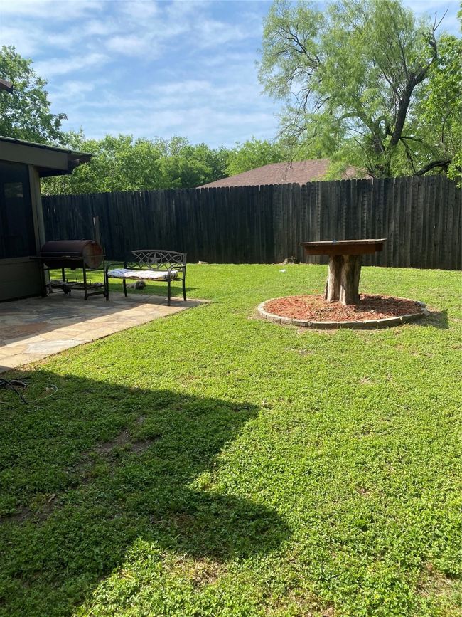 View of yard featuring fence and a patio area | Image 22