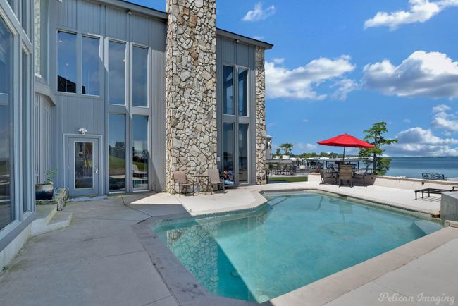 Pool with a water view, a patio area, and outdoor dining area | Image 27