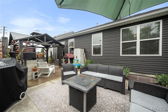 View of patio / terrace featuring a gazebo, an outdoor living space with a fire pit, and a grill | Image 45