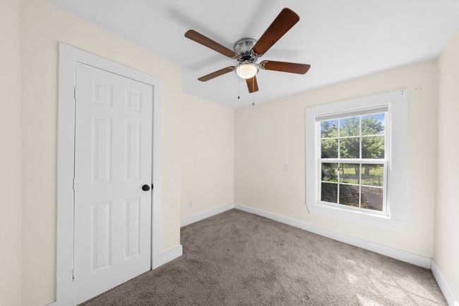 Unfurnished bedroom 4 with carpet flooring, baseboards, and ceiling fan | Image 21