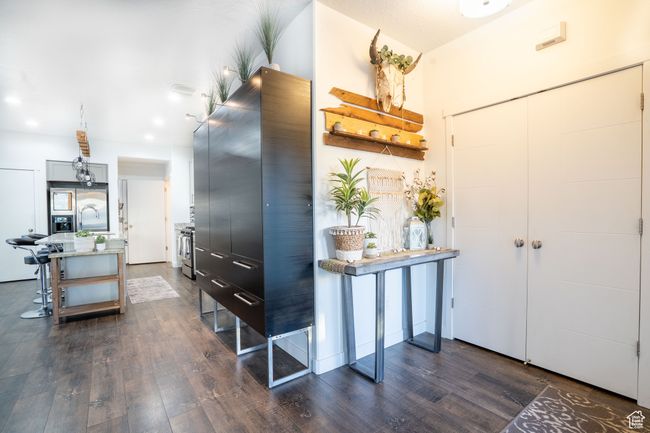 Entryway with dark wood finished floors and extra storage cabinet | Image 8