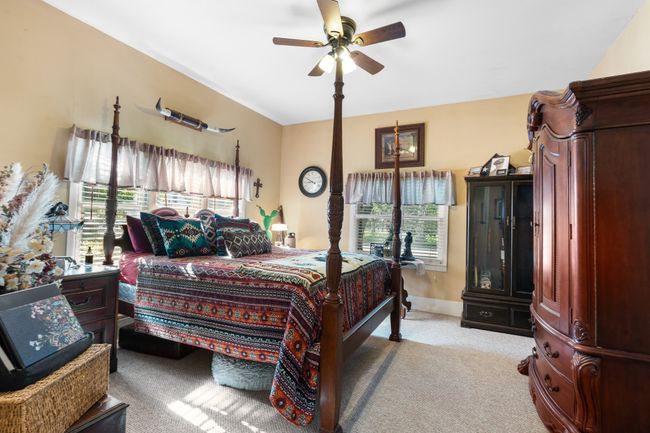 Bedroom with multiple windows, carpet, baseboards, and ceiling fan | Image 22