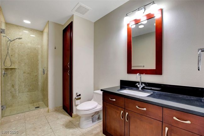 Second bathroom featuring toilet, vanity, visible vents, and a stall shower | Image 29