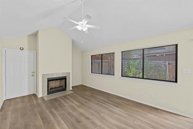 Living room equipped with a tiled, gas fireplace | Image 5