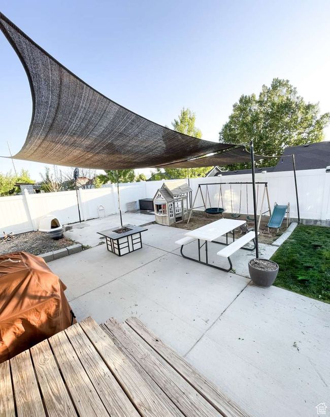 View of community with an outdoor fire pit, a patio, and a fenced backyard | Image 25