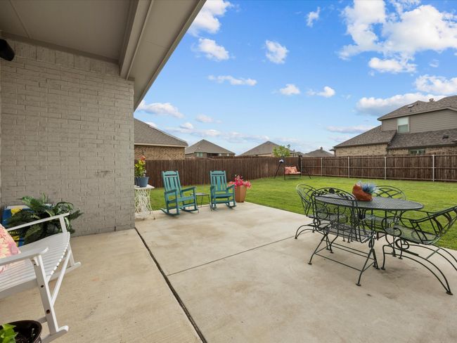 Fenced backyard with outdoor dining area and a patio | Image 26