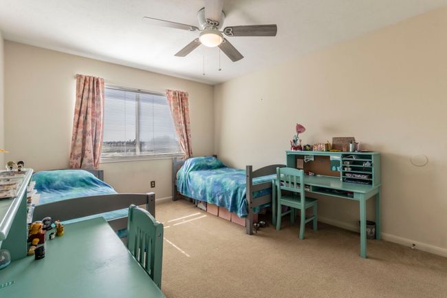 Carpeted bedroom with baseboards and a ceiling fan | Image 26