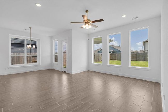 The abundance of windows not only brightens the space but also brings the outdoors in, making the whole area feel airy, warm, and full of life. | Image 8