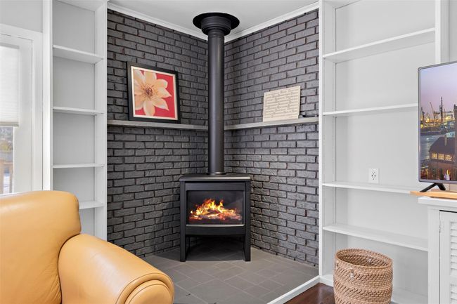 Room details featuring built in features and a wood stove | Image 22