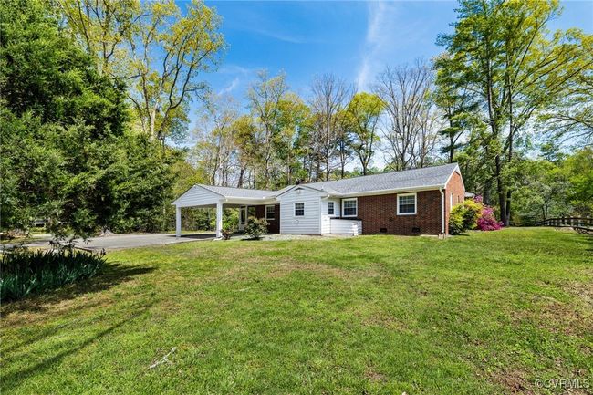 View of front of house featuring a front yard, crawl space, an attached carport, driveway, and brick siding | Image 30